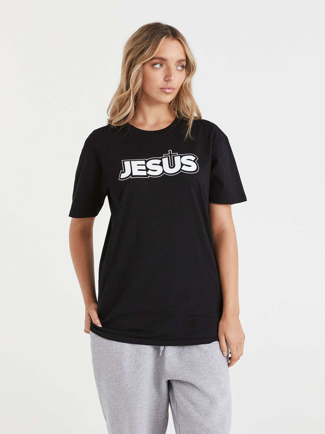 A black t-shirt featuring a cross with the name 'Jesus' printed on the front.